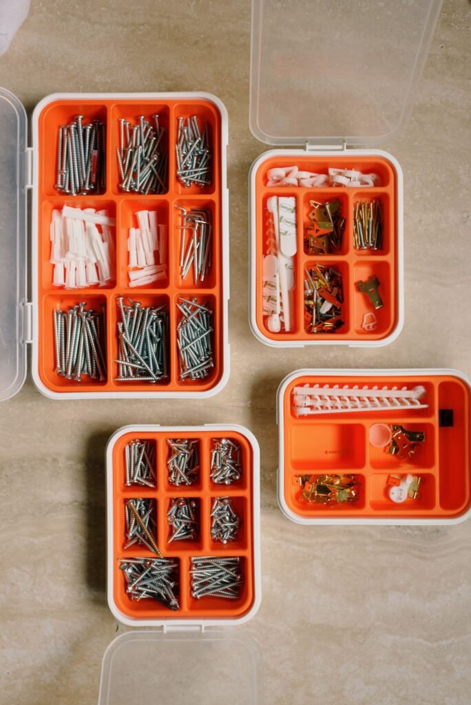 Organised boxes of screws, wall plugs and picture hooks for home repairs